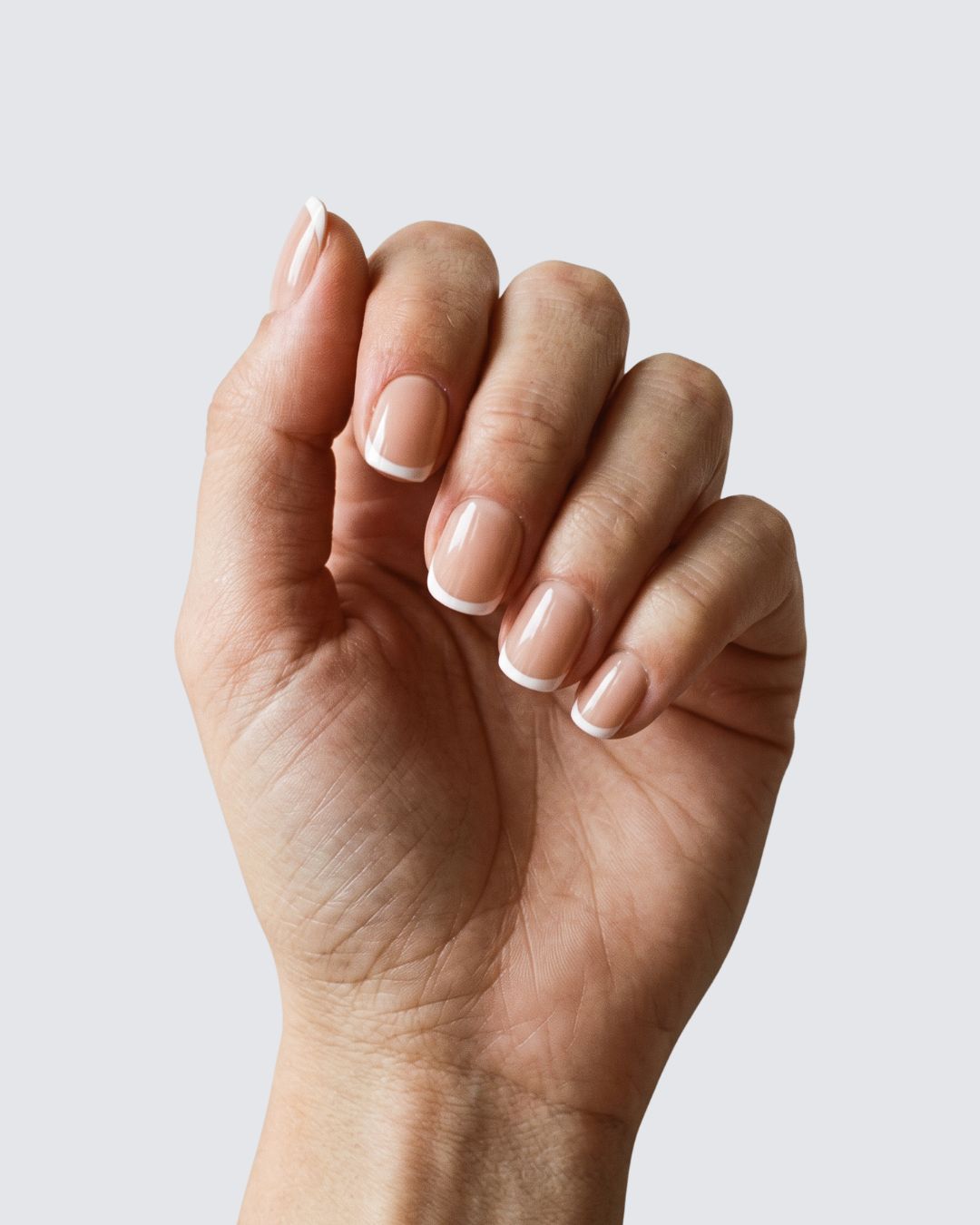 Colette press on nails, glossy warm nude squoval with a white french tip
