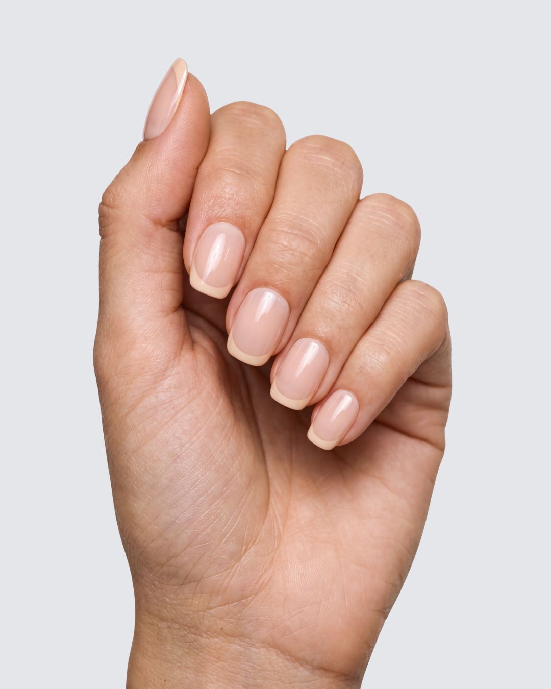 Goldie press on nails, glossy nude squoval with a butter yellow french tip