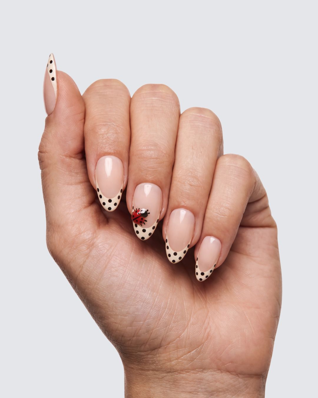 Lady Bug press on nails, sheer nude almond with a white french tip, black polka dots and a ladybug accent nail