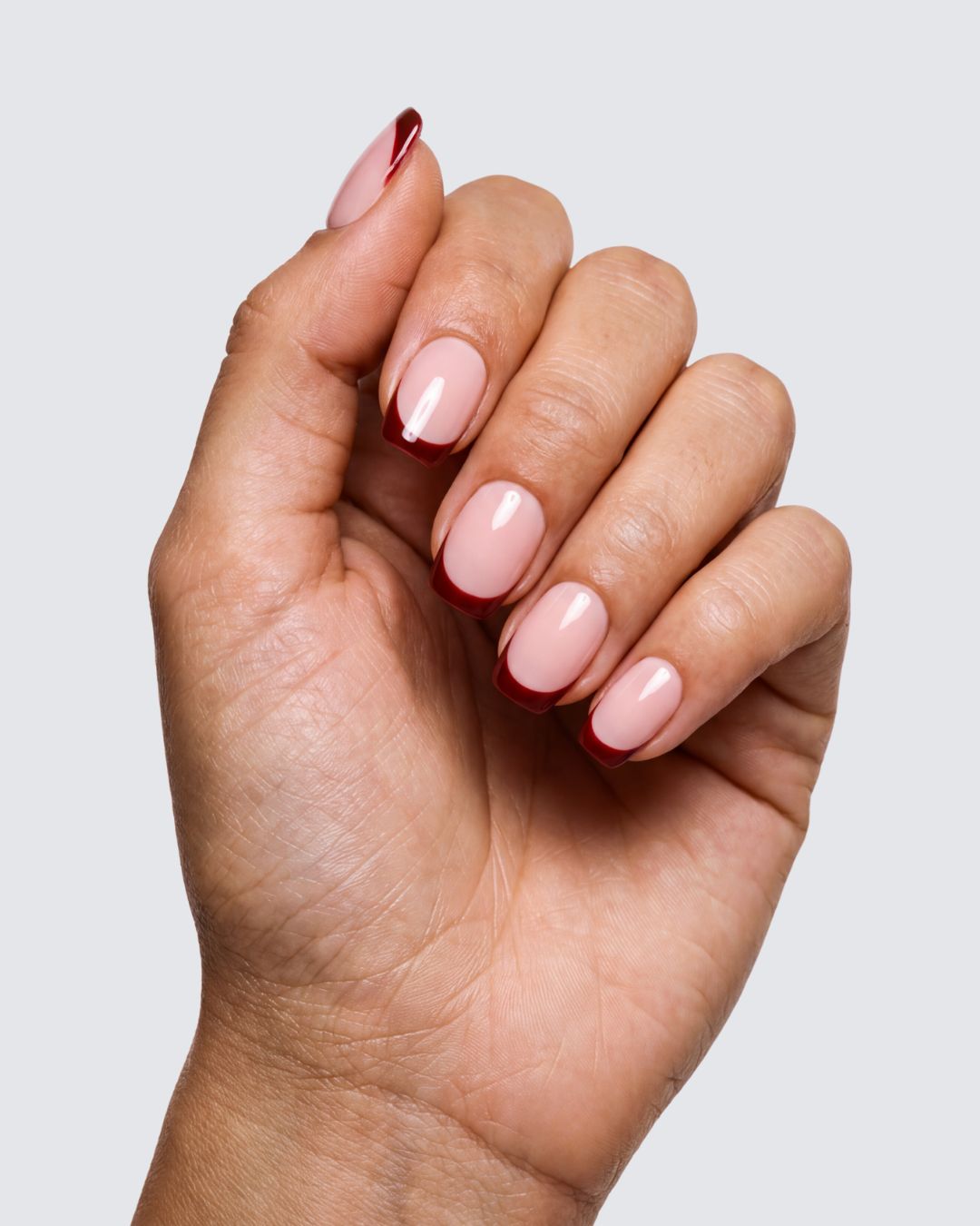 Stella press on nails, glossy nude pink squoval with a deep burgundy french tip