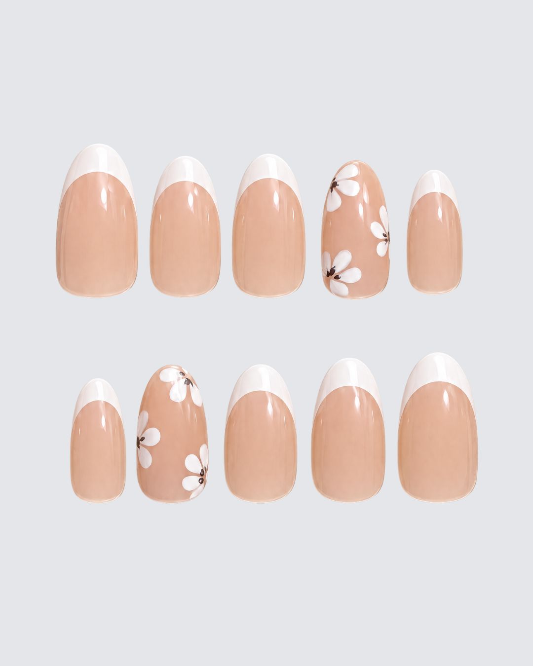White Petals press on nails, warm nude almond with a white french tip and white flower accent nails